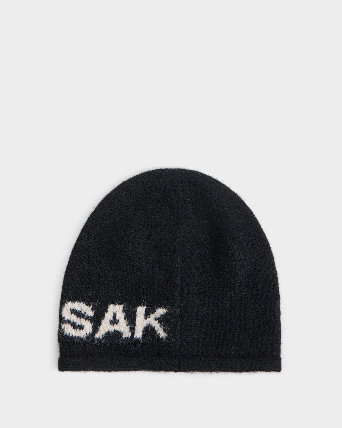 ERIK - U426502 Black knit beanie with the word SAK embroidered in white lettering along the bottom edge.