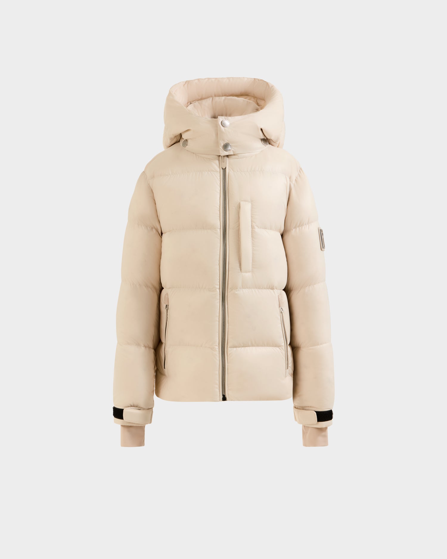The Rudsak VINCE KS - 0124502 Vanilla is a beige unisex puffer jacket with a hood, front zipper, chest pocket, black cuff accents, and RDS-certified down fill, shown on a plain white background.