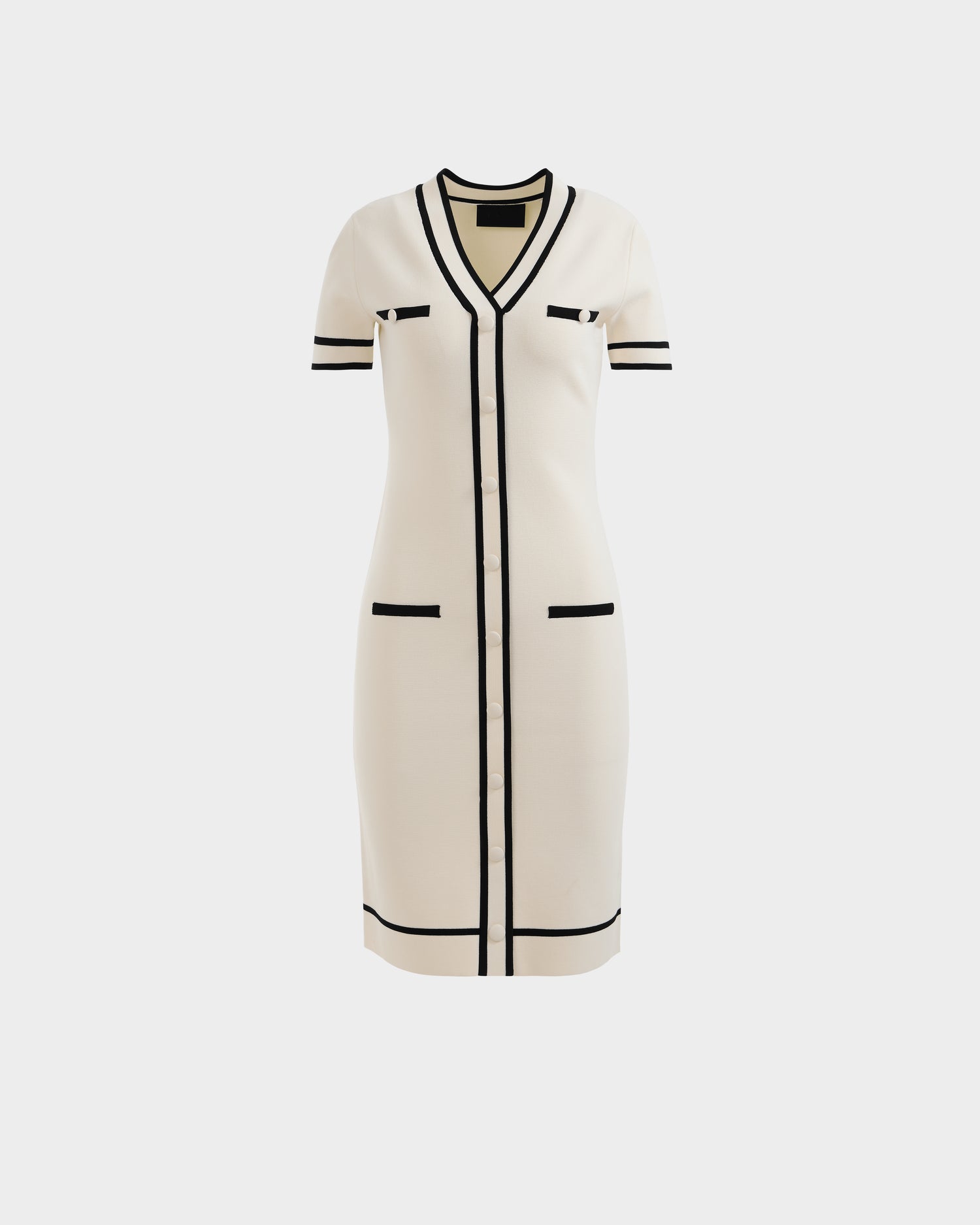 The Rudsak VINNIE - 8526038 Vanilla dress is knee-length with short sleeves, cream color, black trim, V-neckline, button-down front, and four pockets, shown against a plain white background.