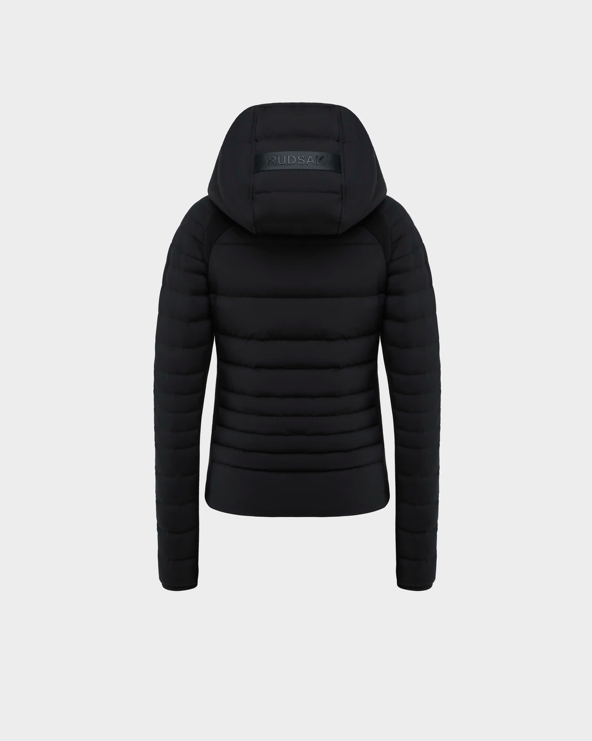 The Rudsak LENA - L124005 Black jacket is shown from the back against a light grey background, featuring horizontal quilting, neoprene inserts, and a visible brand logo on the hood.