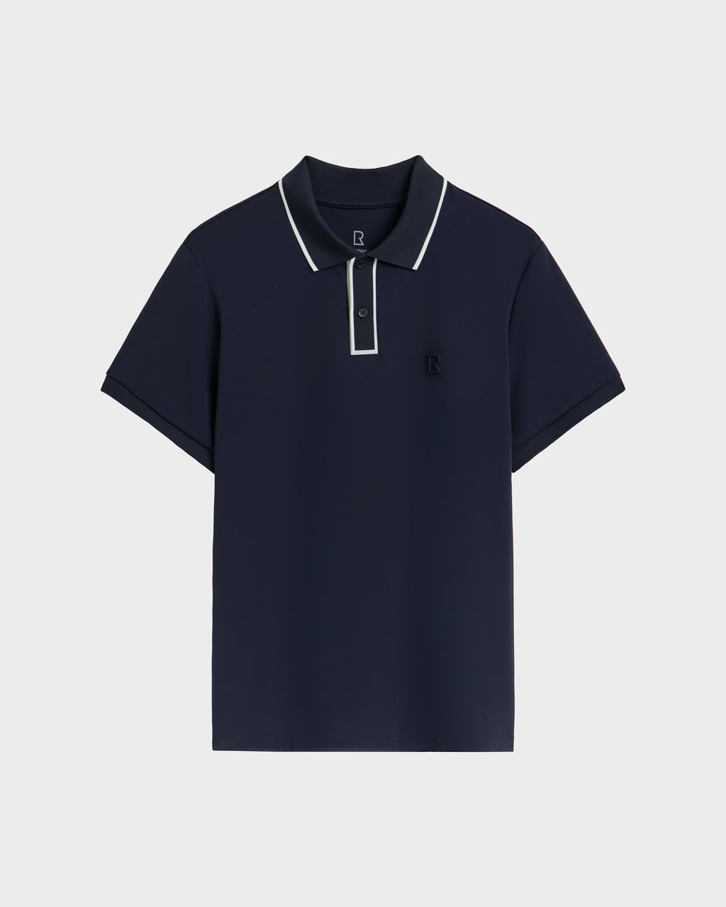 The Rudsak XAVIER - 6524027 Navy mens polo shirt features white trim on the collar and button placket, short sleeves, and a small embroidered logo on the left chest, shown against a plain white background.