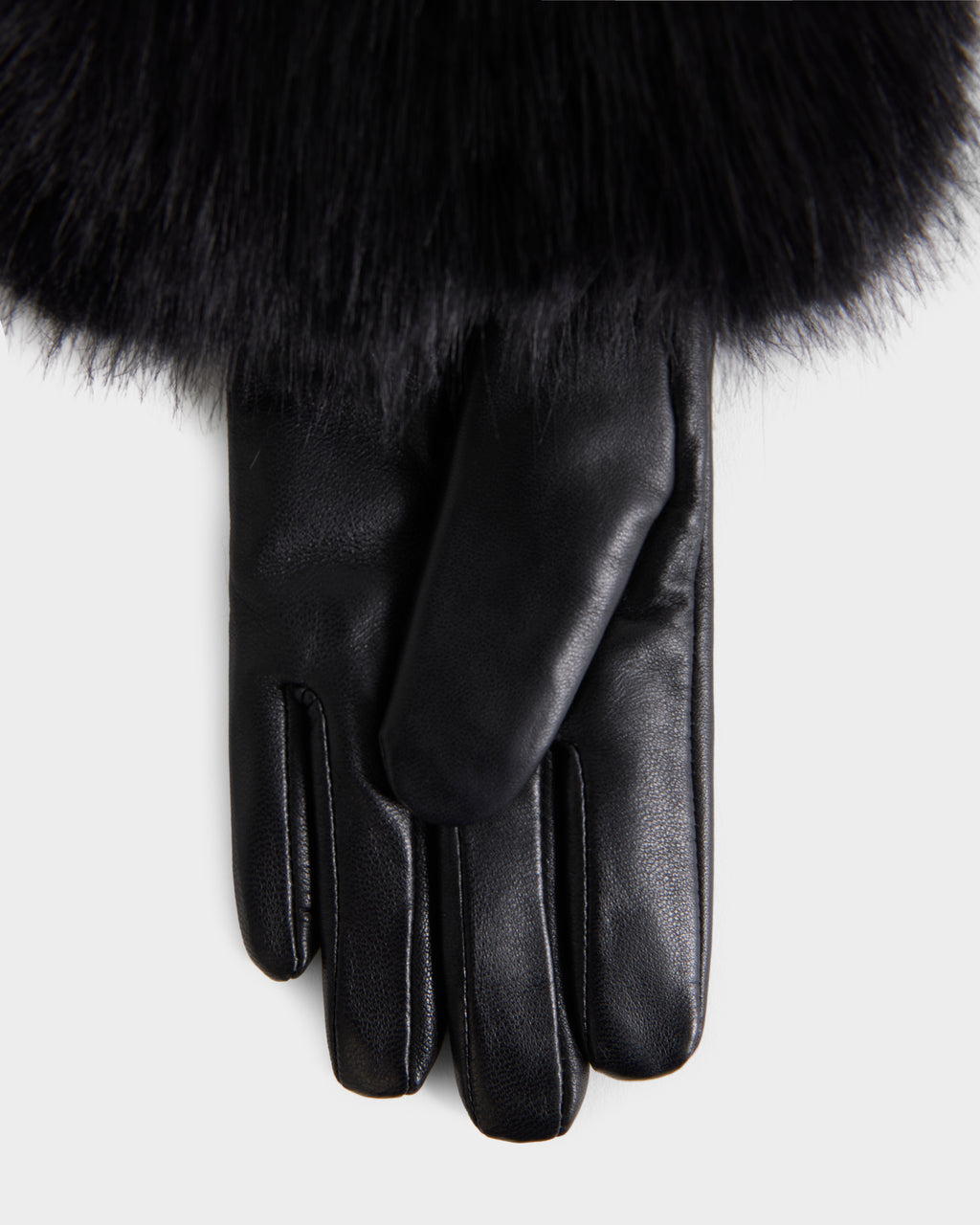 The Rudsak ZAYLA - 8426712 Black glove, crafted from black leather and featuring a thick, dark fur trim at the wrist, is displayed on a plain background.
