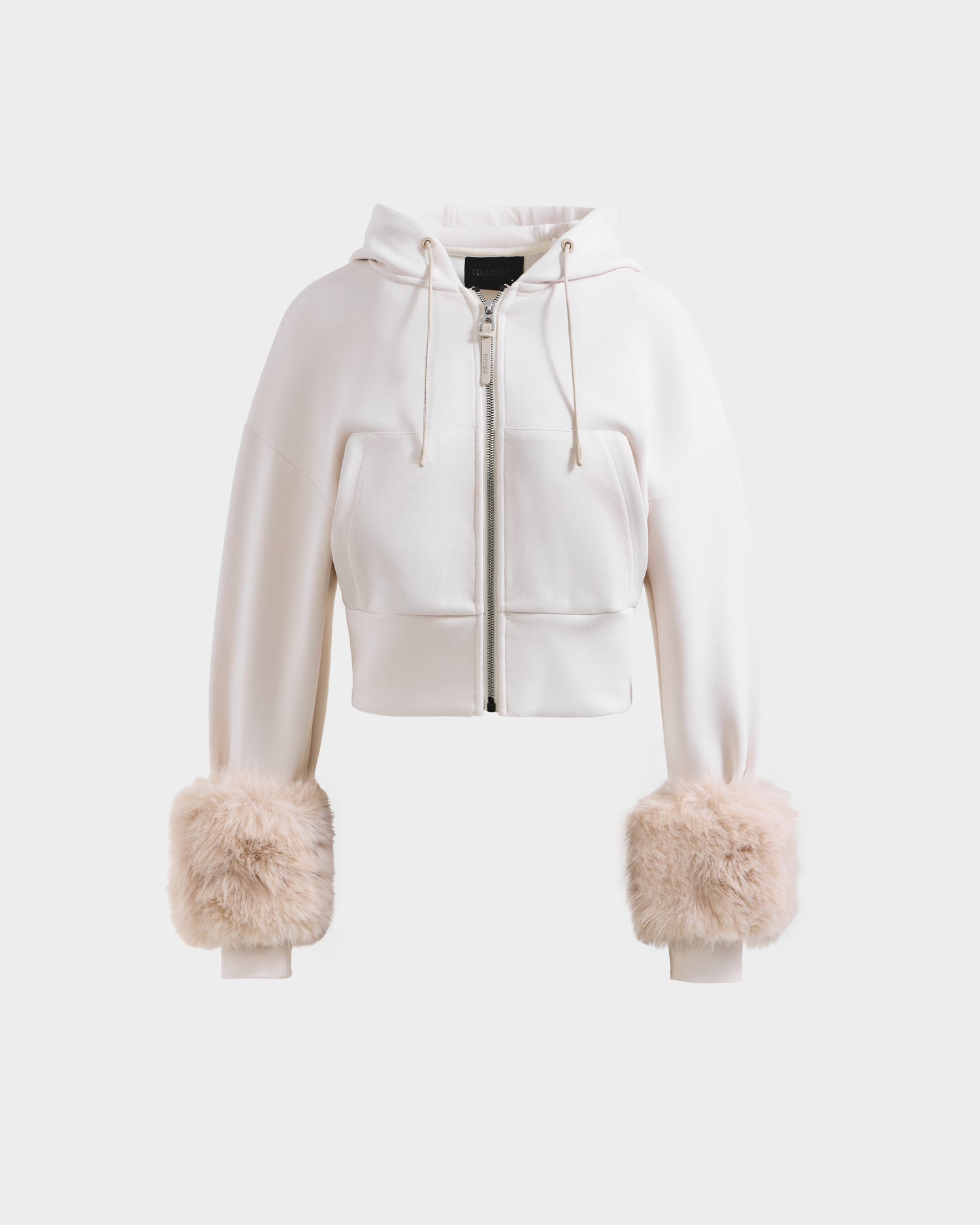 The Rudsak ZILLIA - 8525673 Vanilla is a white cropped zip-up hoodie with drawstrings and large beige faux fur cuffs, ideal for women’s streetwear, shown on a plain white background.