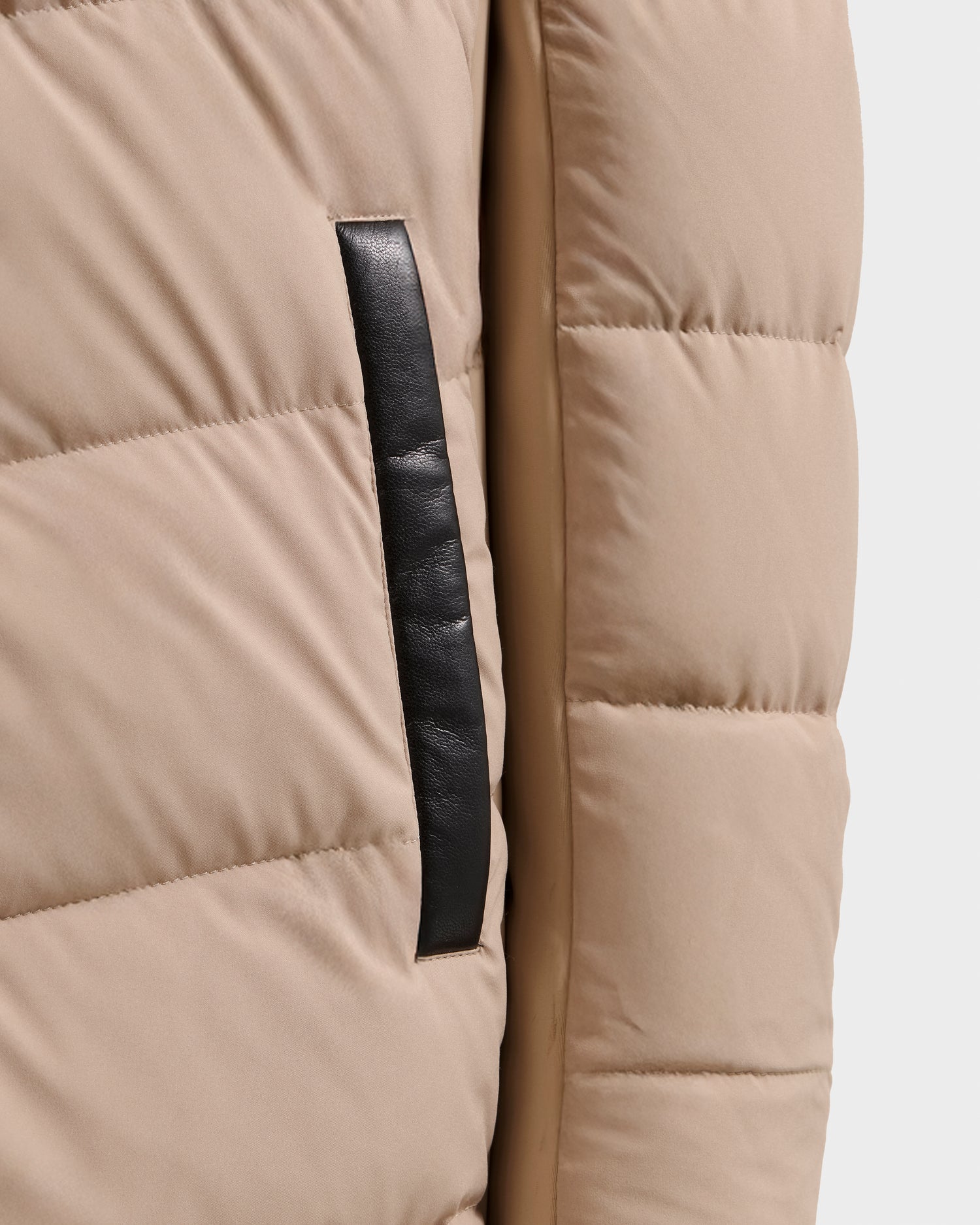 Close-up of the Rudsak LAUREN - 4124520 Taupe coat, featuring beige quilted down, horizontal stitching, and a front vertical black leather-trimmed pocket.