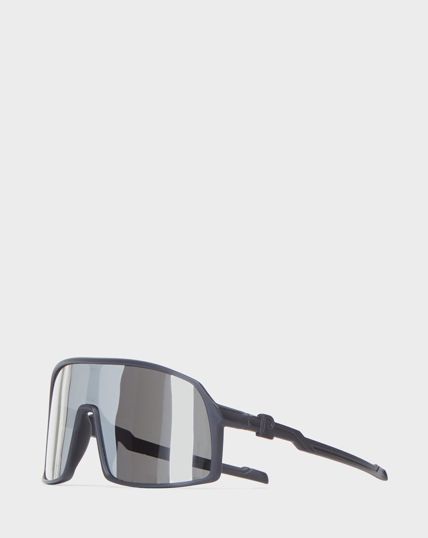 A pair of black AKSEL - 9422031 BLACK METALLIC sunglasses by Rudsak, featuring large reflective UV Block lenses, is displayed against a plain white background.