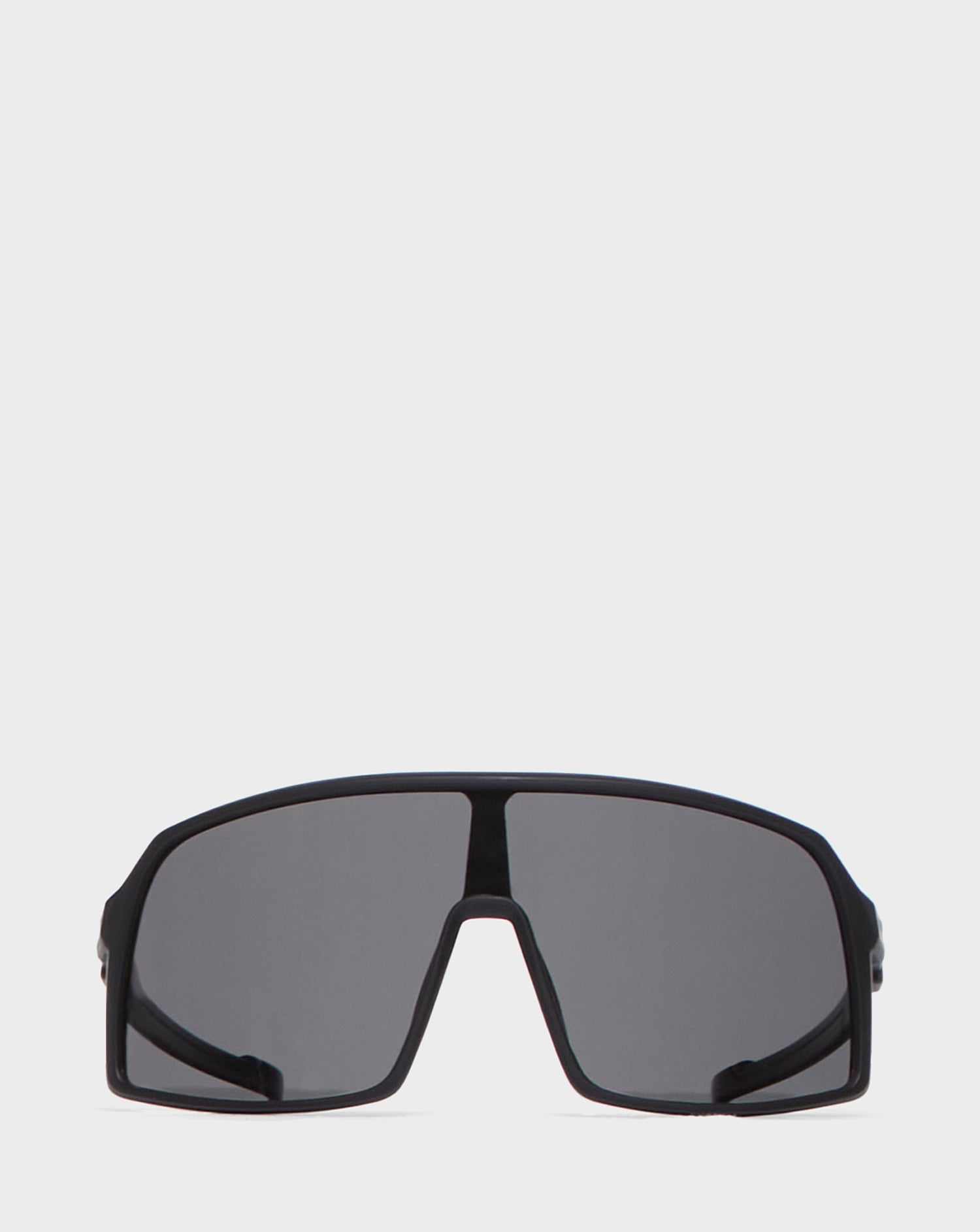 A pair of Rudsak AKSEL - 9422031 BLACK wraparound sunglasses with a single wide, dark-tinted UV Block Lens and a thick frame, displayed against a plain white background.