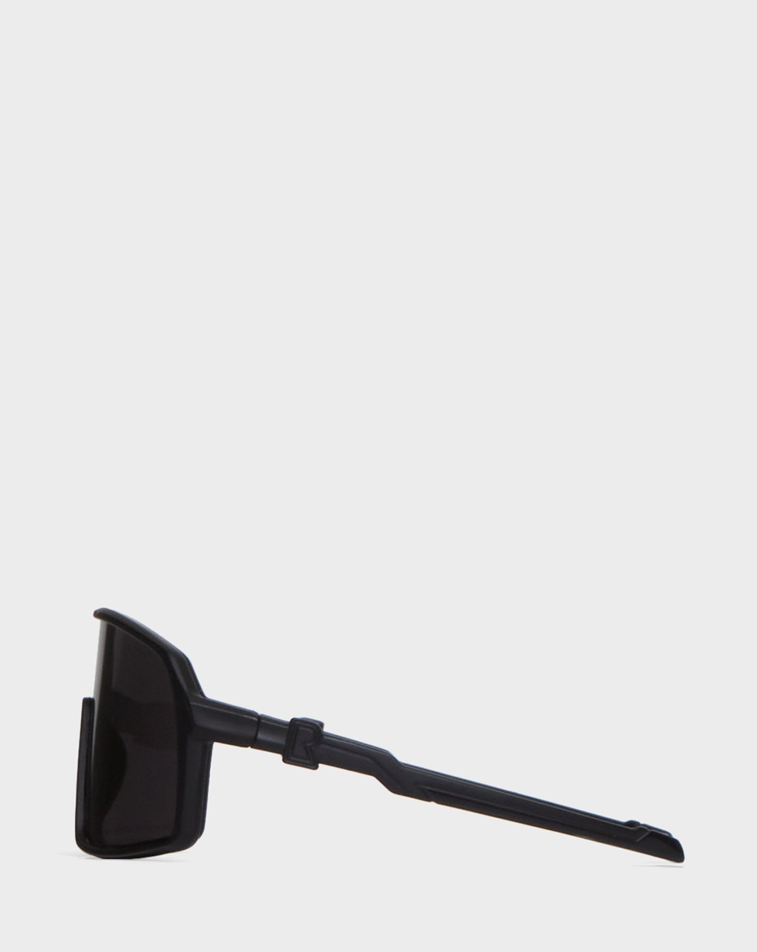 A pair of Rudsak AKSEL - 9422031 BLACK sunglasses, folded flat and shown sideways on a plain white background, feature UV Block Lenses for superior eye protection.