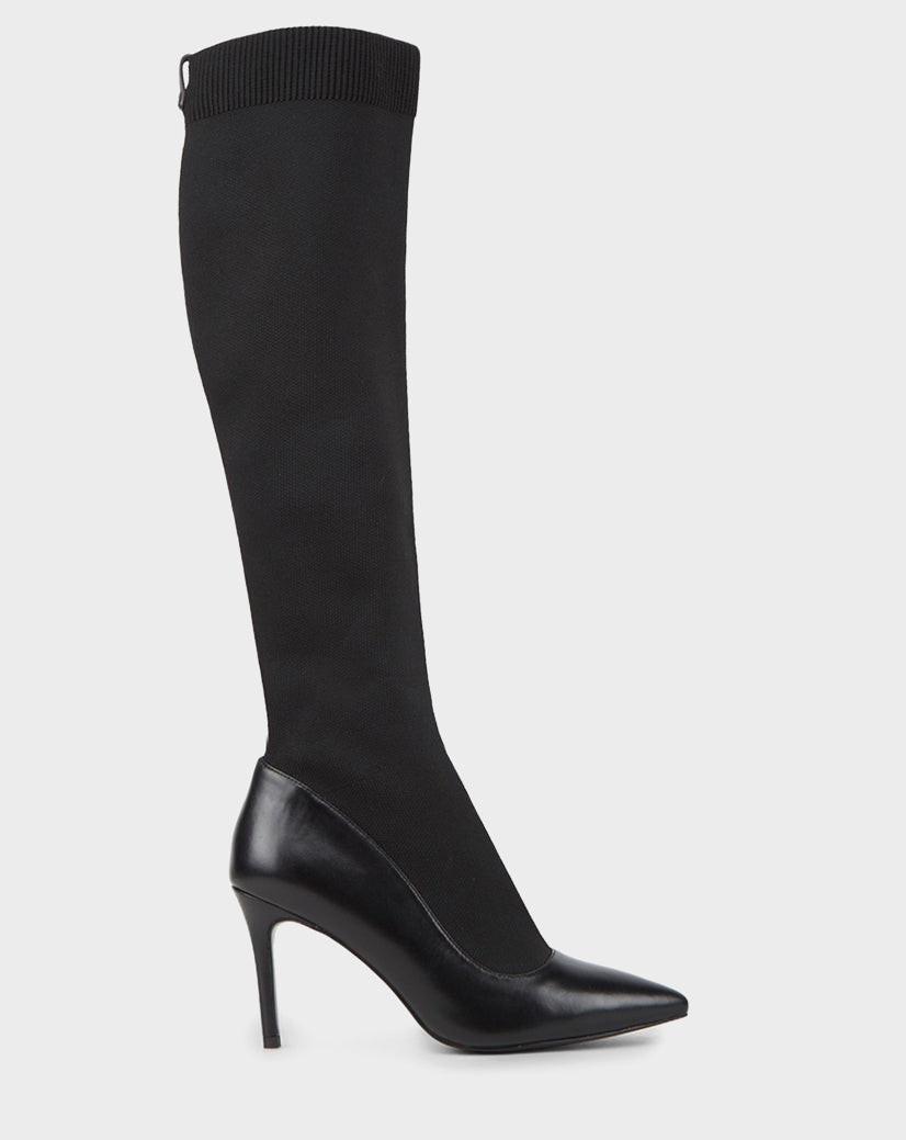 The TIGRIS - CA EN 8218532 BLACK by Rudsak is a single black knee-high statement boot featuring a pointed toe, high stiletto heel, ribbed elastic top, stretch fabric shaft, and sleek leather foot and heel.