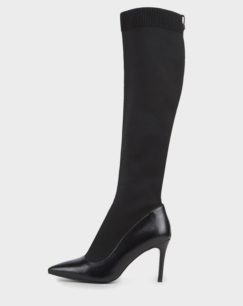 The Rudsak TIGRIS - CA EN 8218532 BLACK is a knee-high, black stiletto boot with a pointed toe, fitted stretch shaft, and ribbed top—ideal for making a standout statement.