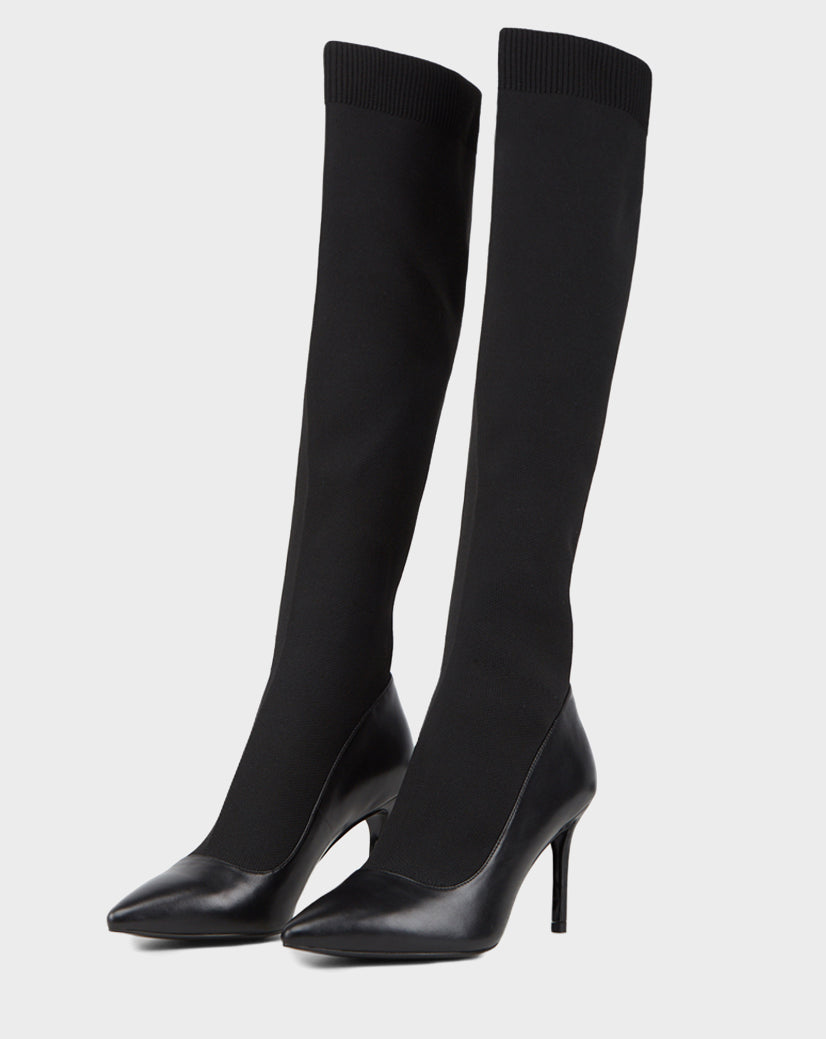 The TIGRIS - CA EN 8218532 BLACK by Rudsak features black high-heeled boots with pointed toes, a sleek leather finish, and a stretchy sock-like knit upper for style and comfort.