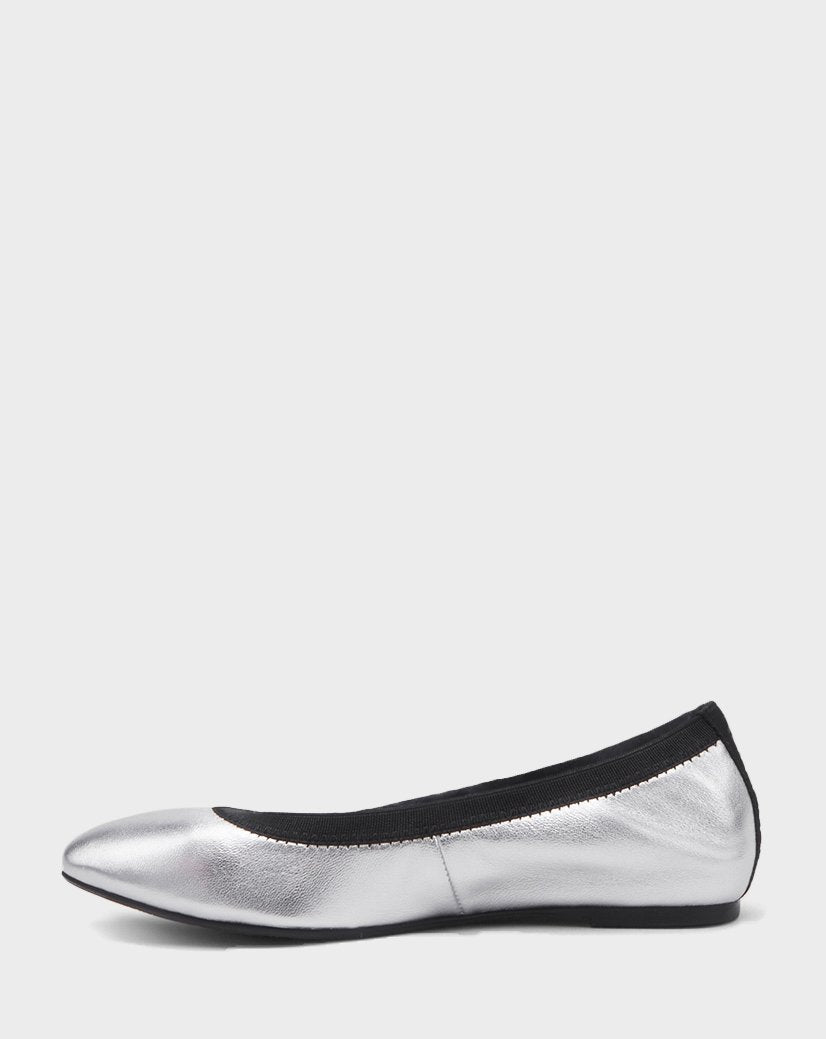 The Rudsak TESSALY - CA EN 8220037 SILVER is a metallic silver leather ballerina flat with black trim around the opening, displayed in side profile on a plain light gray background.