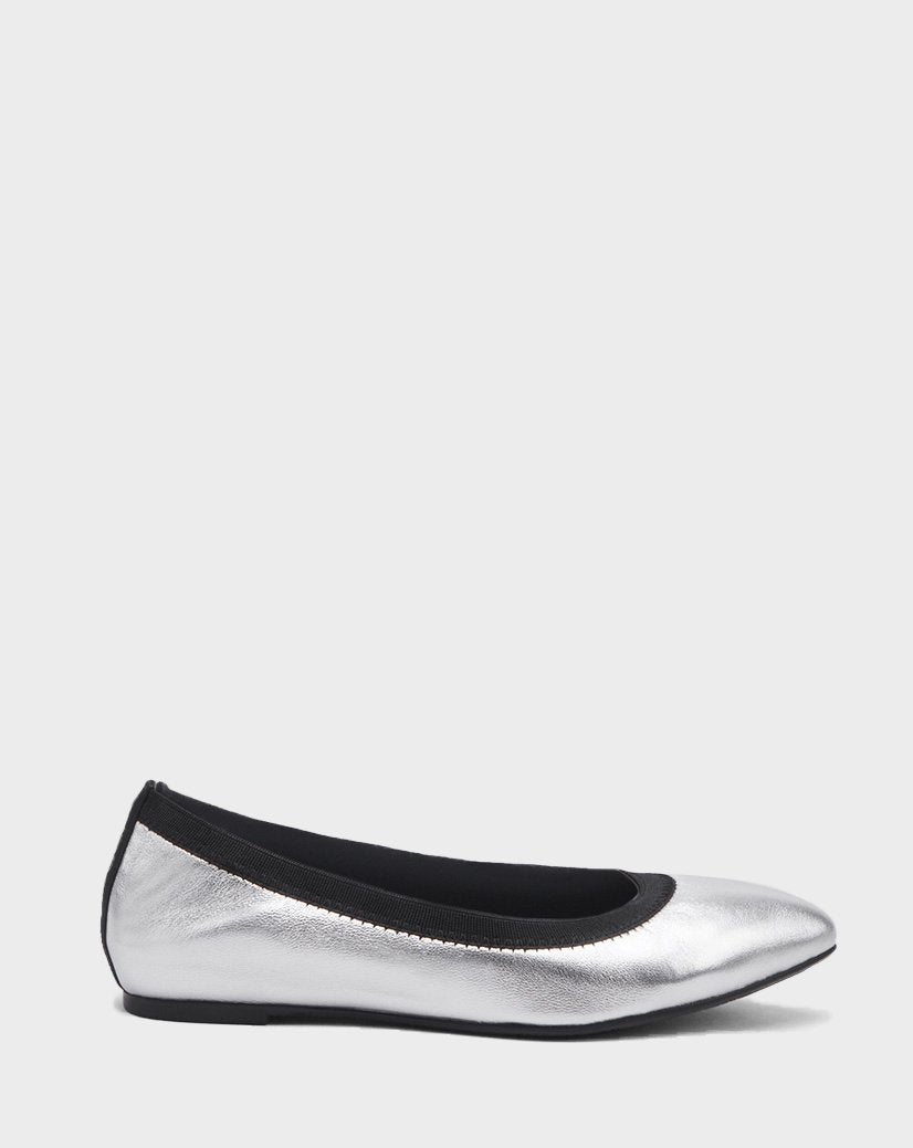 The Rudsak TESSALY - CA EN 8220037 SILVER is a silver leather ballerina flat with a rounded toe and black trim, displayed in side profile against a plain light gray background.