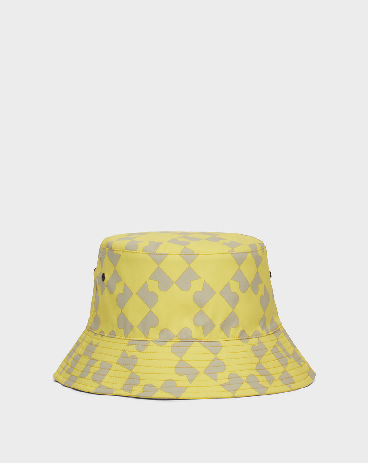 The Rudsak AYLA - 9422004 YELLOW is a unisex reversible yellow bucket hat with a gray puzzle piece pattern and two metal eyelets on each side, shown on a plain white background—perfect for adding flair to any outfit.